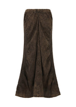 The TENMOKU COTTON skirt by HaaT is long, brown, and textured with a flared hem and subtle wavy pattern. Garment-dyed for a vintage look, it features a 3D texture, slightly distressed finish, and an elastic waistband for comfort.