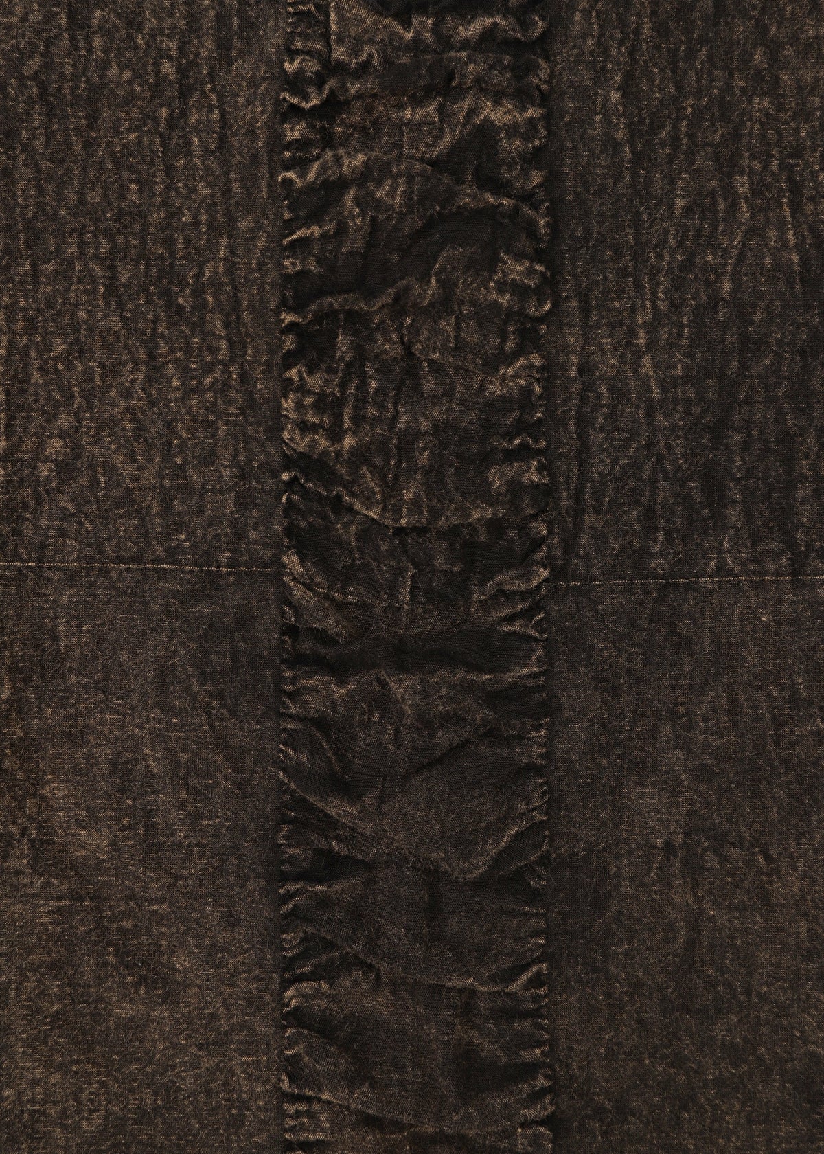 A close-up of HaaT's TENMOKU COTTON shows its garment-dyed fabric with three-dimensional texture and a central vertical strip of gathered, ruffled material contrasting the smoother sides. view 5 of 8