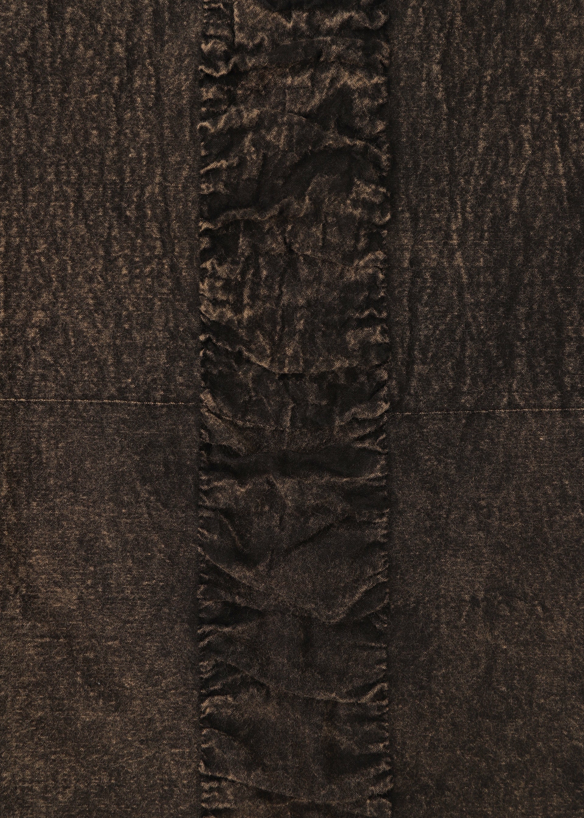 Zoomed view A close-up of HaaT's TENMOKU COTTON shows its garment-dyed fabric with three-dimensional texture and a central vertical strip of gathered, ruffled material contrasting the smoother sides.