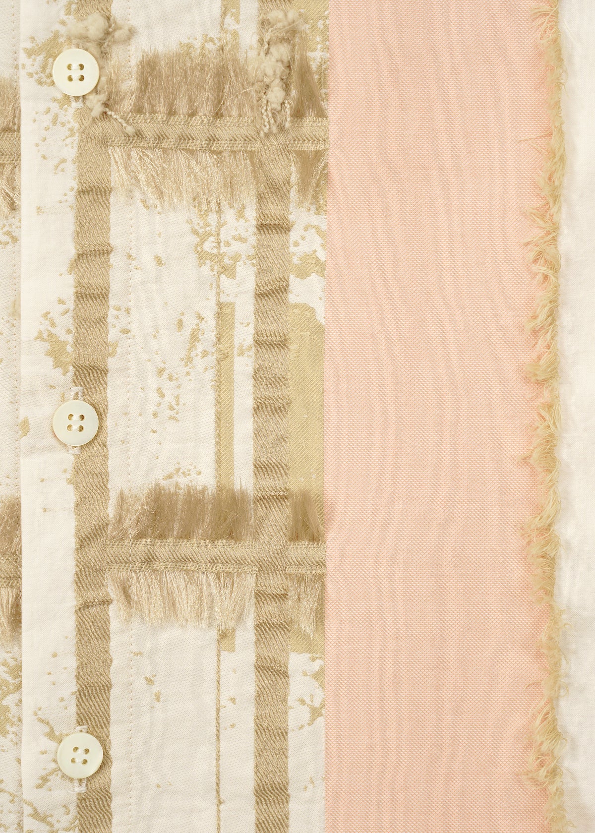 Close-up of HaaT's KASANEGAKE: cream fabric with a grid of textured fringes and beige buttons, accented by a solid pink stripe with frayed edges on the right, highlighting its varied texture and layered design. view 5 of 8