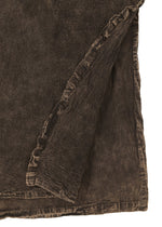 Close-up of HaaT’s TENMOKU COTTON: a dark brown, garment-dyed fabric with visible stitched seam and a folded corner, highlighting the material’s thickness, subtle color variations, and textured finish.