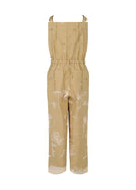 The KOKUYU by HaaT is a tan sleeveless jacquard jumpsuit featuring adjustable shoulder ties, a cinched waist, wide legs, and an abstract white print that adds dimension to this chic piece. Shown on a plain white background.