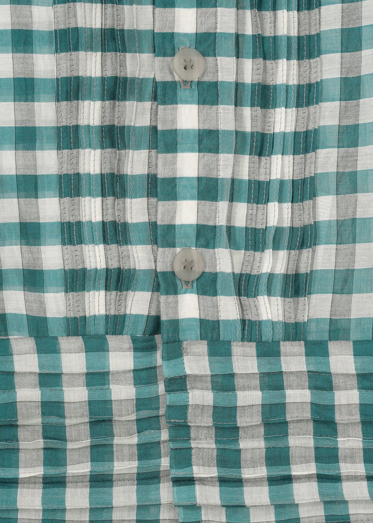Close-up of the HaaT 2 SIDE PINTUCKING shirt—green, white, and gray plaid with vertical pintucks and three light buttons. Cotton silk fabric texture and detailed stitching are clearly visible. view 5 of 9