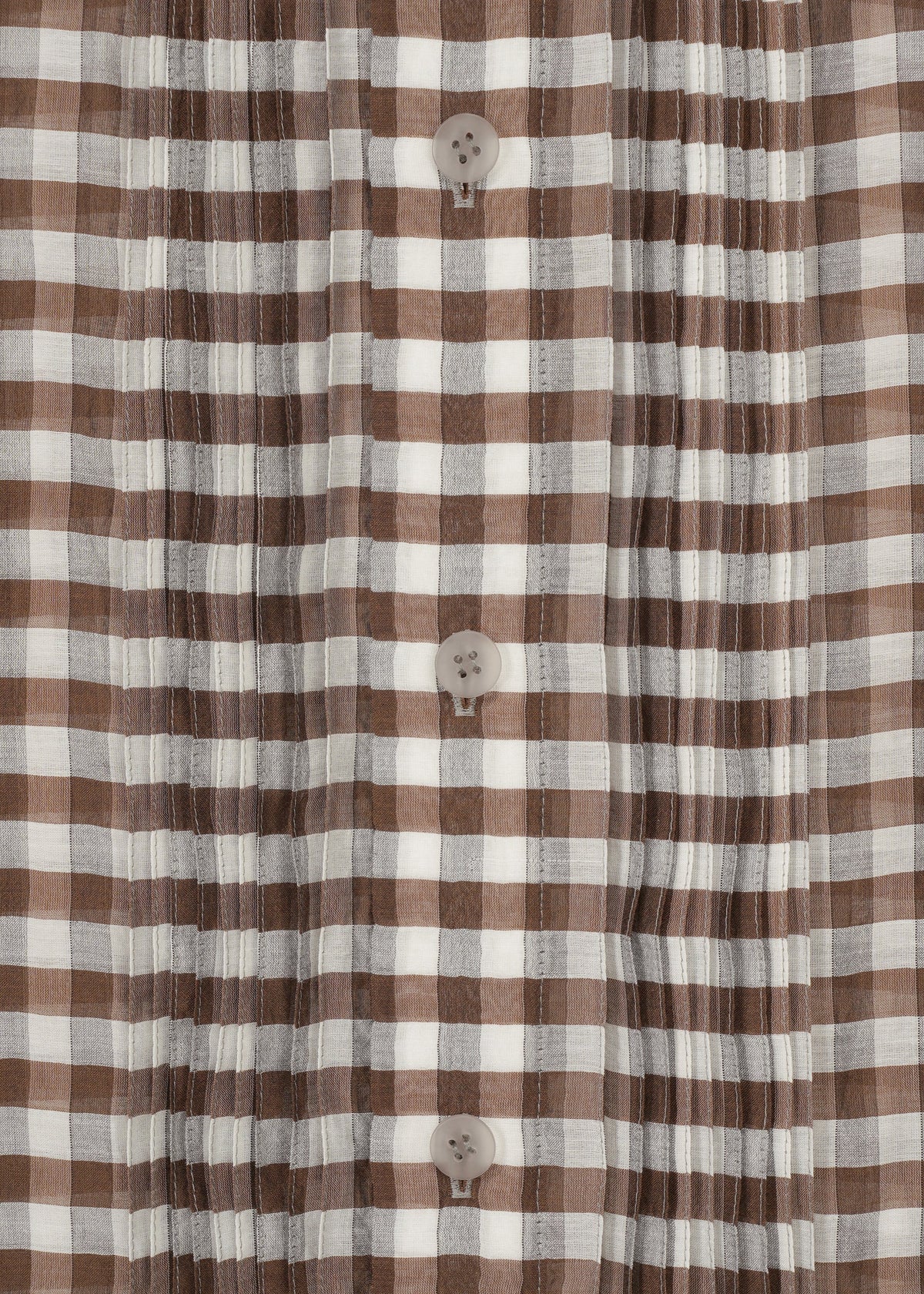 Close-up of the HaaT 2 SIDE PINTUCKING shirt, featuring brown and white gingham checks, vertical pintucks, and four beige center buttons. view 5 of 8