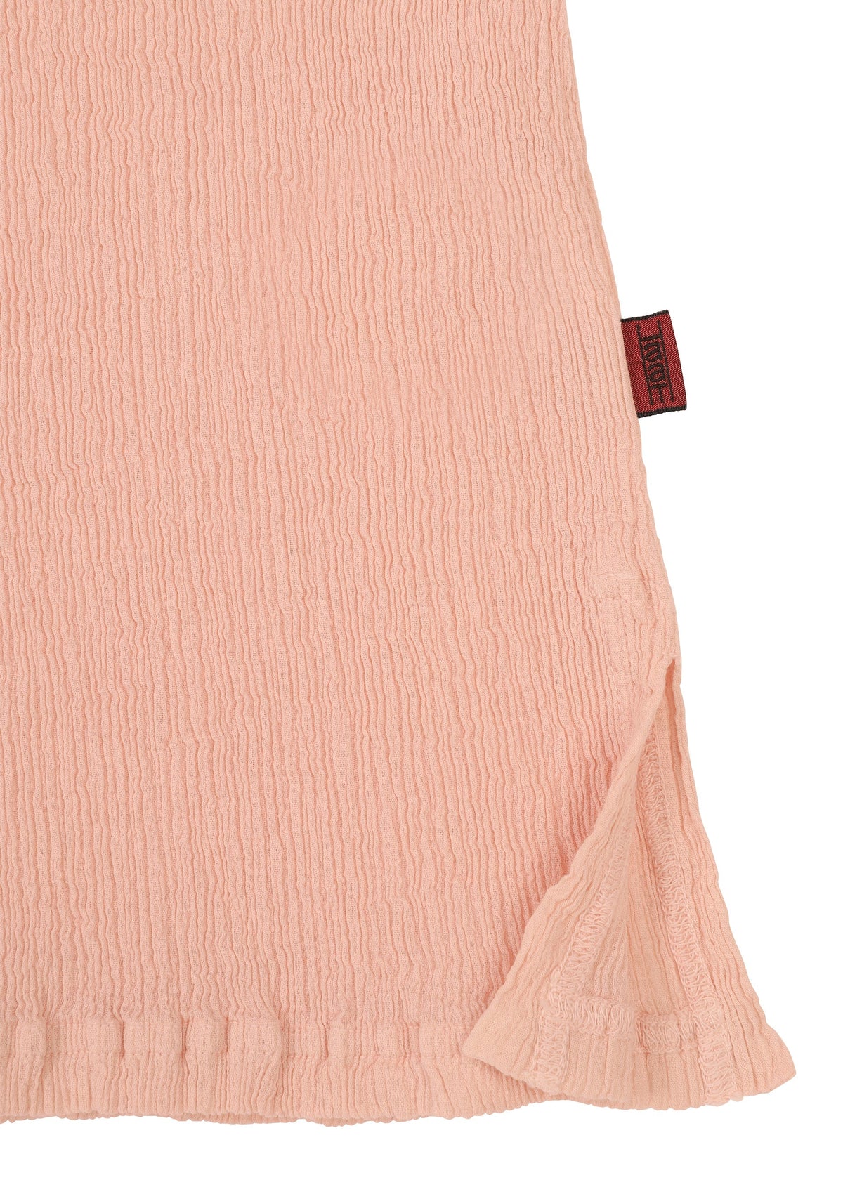 A close-up of KYO CHIJIMI FEBRUARY by HaaT shows light pink, crinkled fabric with a hem slit and a dark red side tag—ideal for an ultra-fine cotton round-neck top. view 5 of 9
