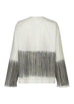 SAZANAMI by HaaT is a white organic cotton long-sleeve top with a loose fit, accented by hand-painted gray and black vertical brushstrokes on the hem and cuffs. The unique design emphasizes the back of the garment.