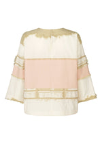 The KASANEGAKE top by HaaT features a jacquard weave, boxy silhouette, and loose fit with cream, blush pink, and beige panels. Frayed edges and wide three-quarter sleeves complete the design, which is layered and especially striking from the back.