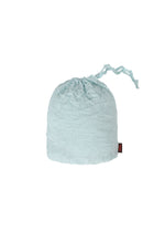 A light blue KUMO SHIBORI SHIRT by HaaT, featuring a crinkled Arimatsu Shibori-inspired texture, is displayed against a plain white background. A small black and red tag appears on the right side.