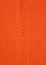 Close-up of the orange KYO CHIJIMI MAY cardigan by HaaT, crafted from ultra-fine cotton yarn with four matching buttons, a round neck, long sleeves, wavy textured fabric, and visible stitching.