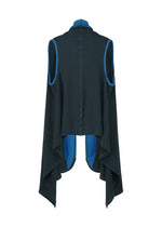 The HaaT TRI COLOR WOOL is a sleeveless black vest with blue trim, crafted from soft jersey fabric. It features a high collar, long draped sides for an asymmetrical hem, and bright blue inner lining visible at the edges.