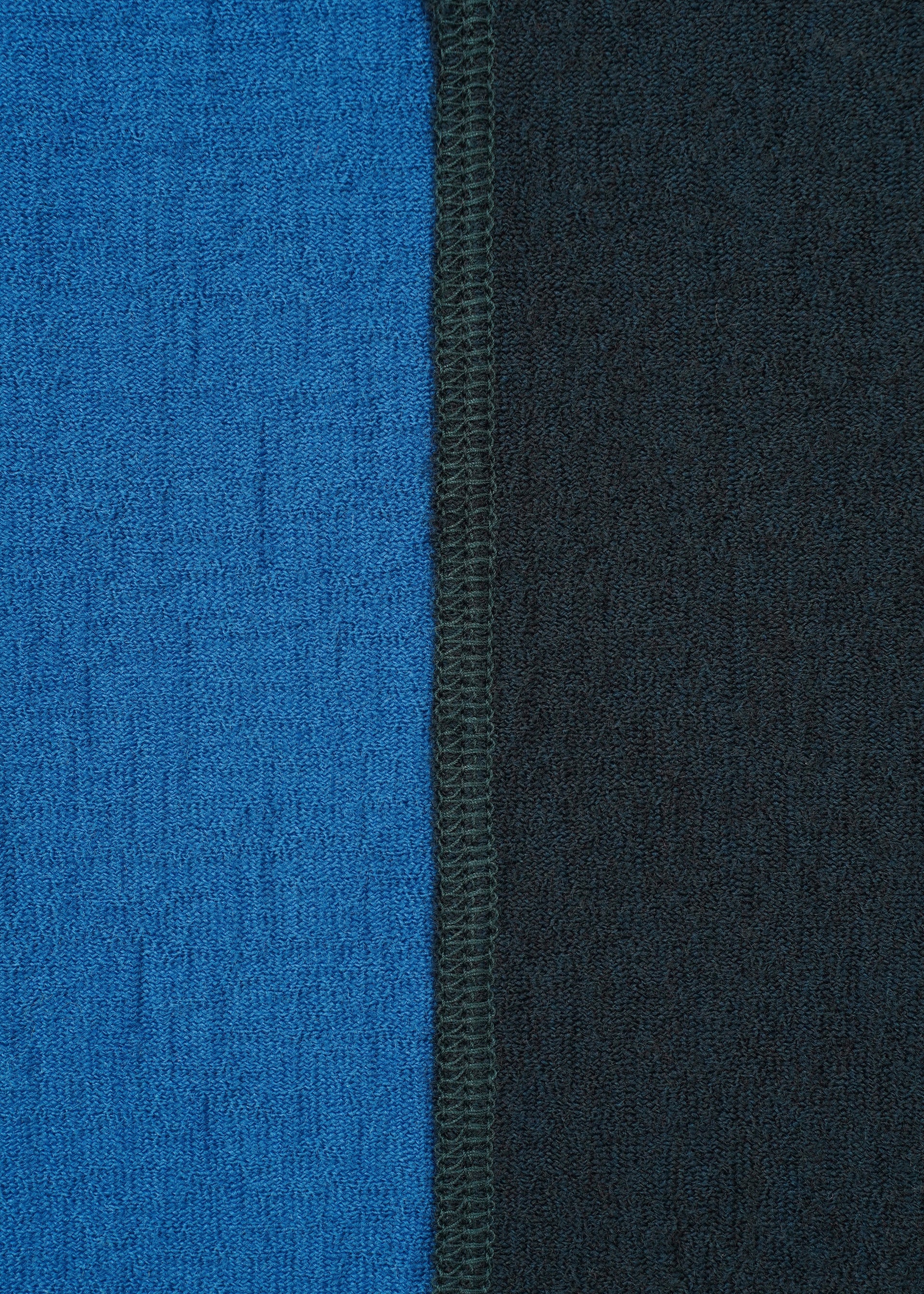Zoomed view Close-up of two textured TRI COLOR WOOL jersey panels by HaaT, stitched vertically—blue on the left and black on the right—with a visible center seam.