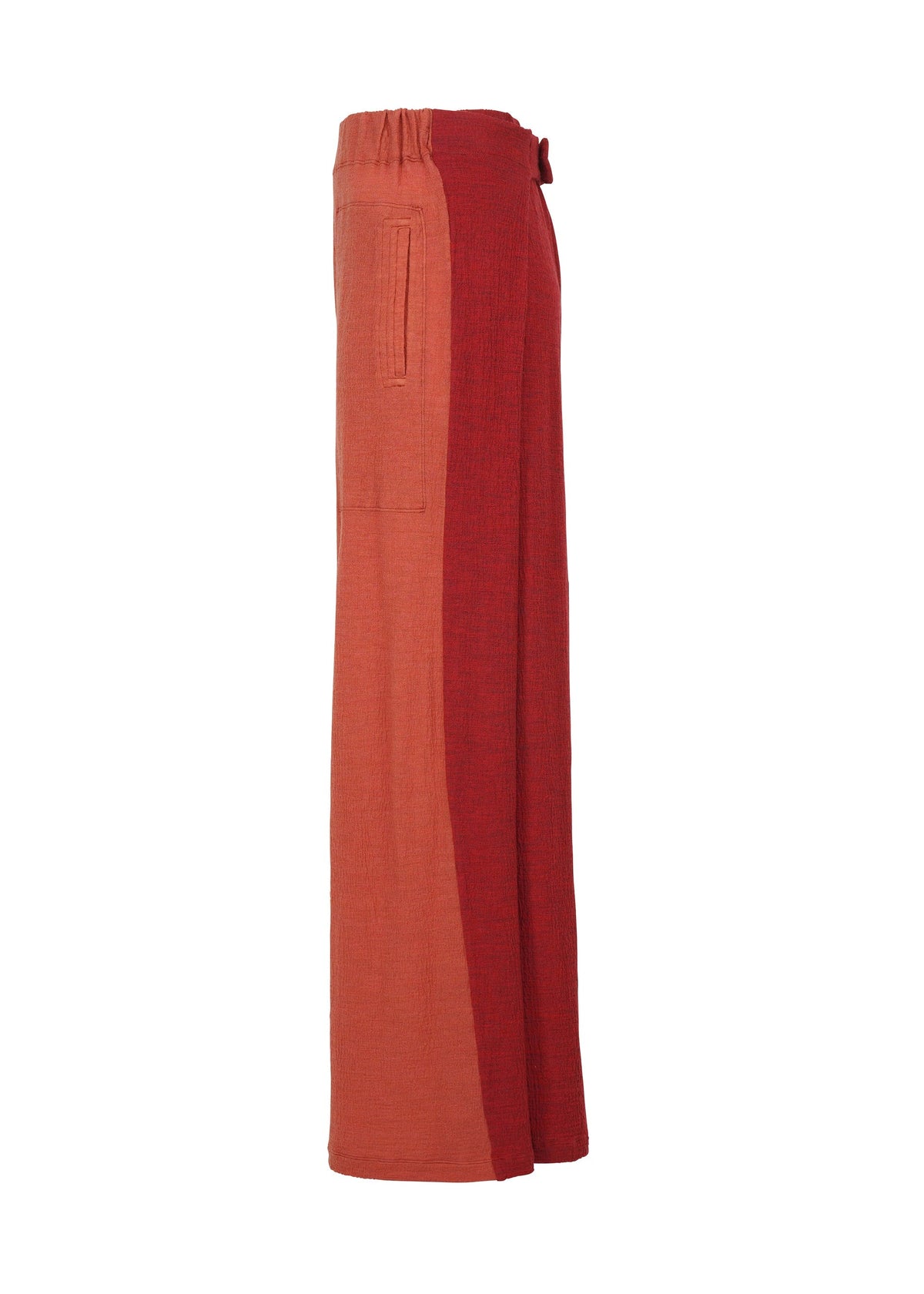 Side view of HaaT's TRI COLOR WOOL relaxed fit, wide-leg pants with an elastic waistband, crafted from rust and brick red two-tone fabric, and a single left-side pocket. view 8 of 13