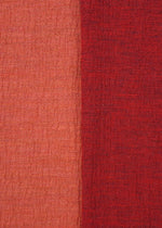 Close-up of HaaT's TRI COLOR WOOL fabric: vertically split with light orange-red on the left, deeper red on the right. Both textured sides have a woven, slightly rough look—ideal for relaxed merino wool or multicolor jersey pants.