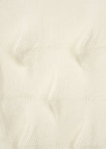 Close-up of the HaaT ZIG ZAG KNIT, a cream-colored organic cotton fabric featuring ribbed texture and raised, pointed sections in horizontal rows.