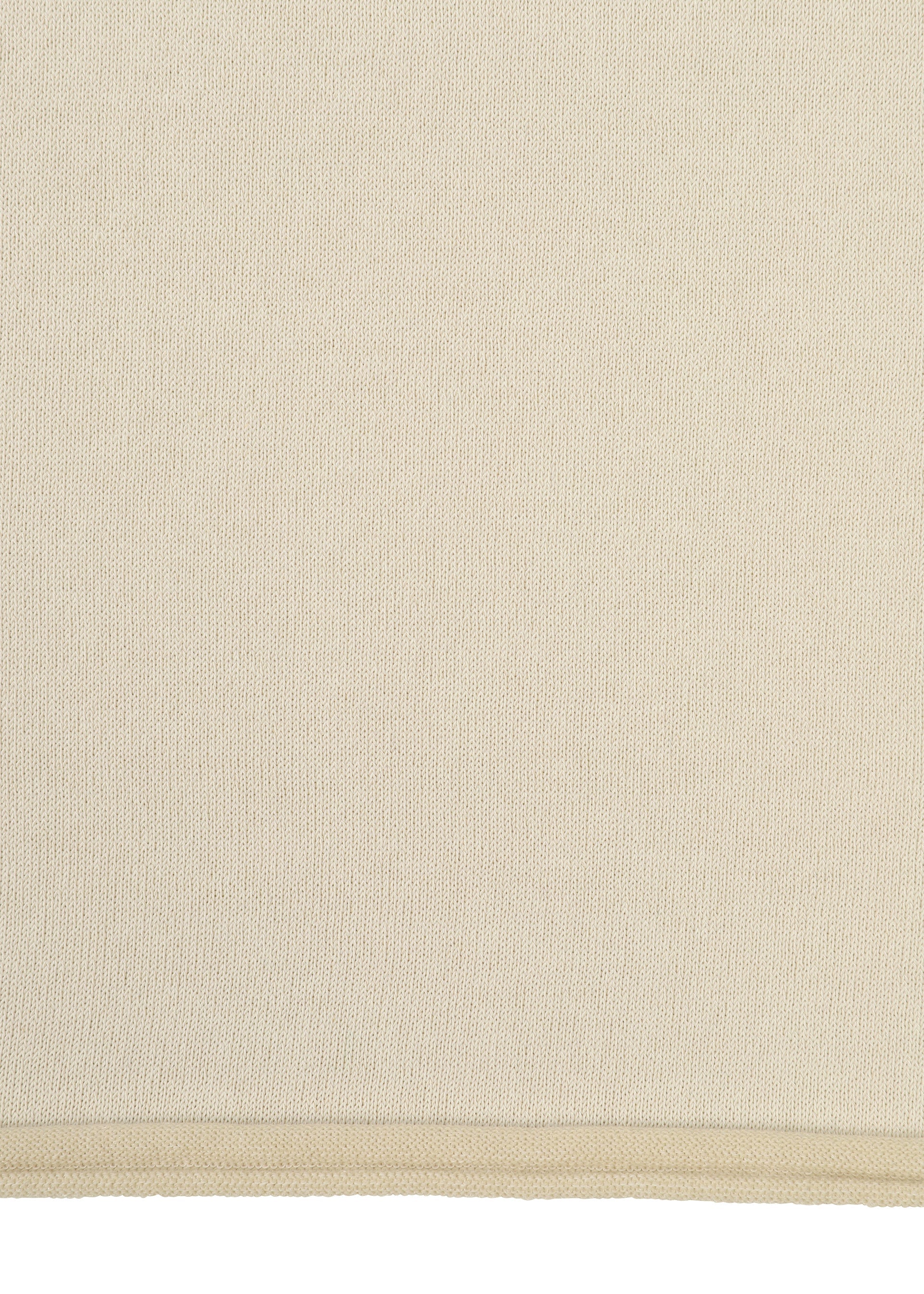 Zoomed view A close-up of PLATED LINES by HaaT shows a beige organic cotton fabric with a subtle woven texture and a visible stitched edge along the bottom.