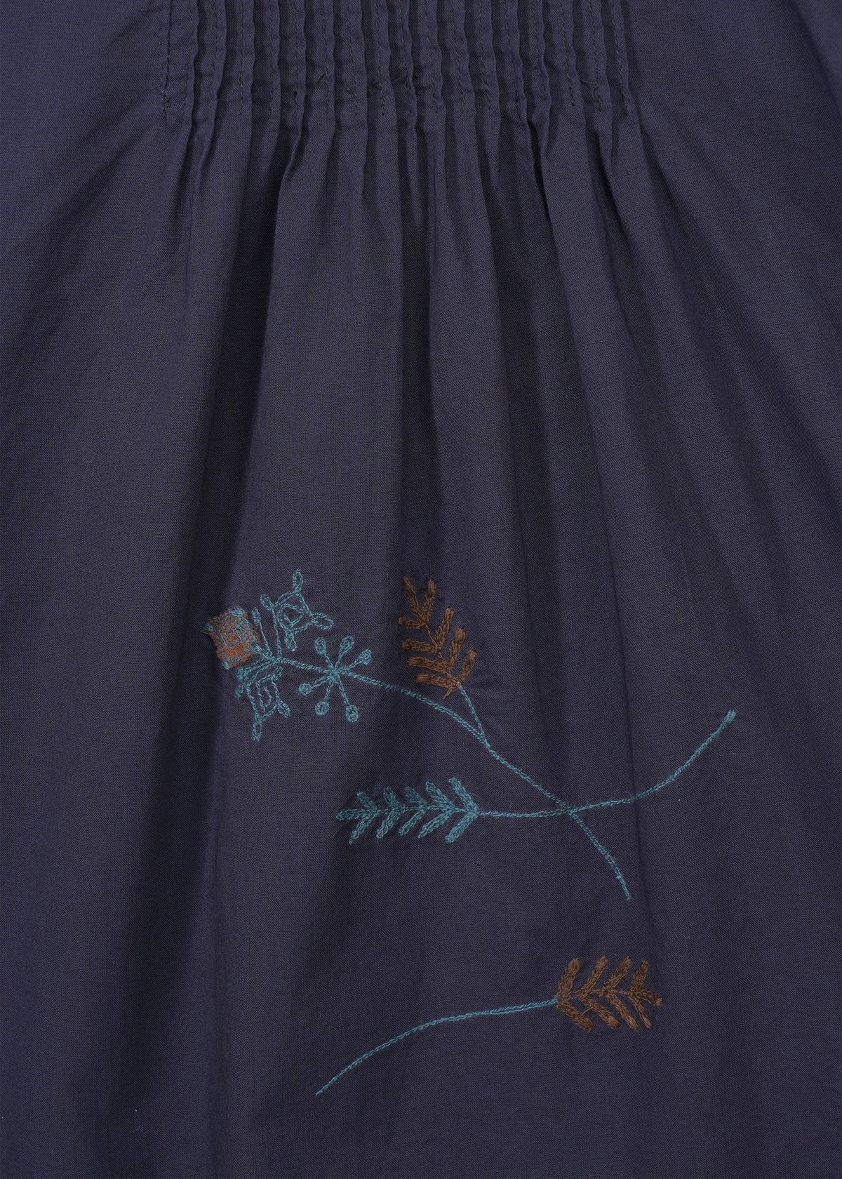 The DAMI LEAVES pants by HaaT are dark navy cotton with a gathered seam at the top and simple handmade Indian embroidery of light blue and brown floral and leaf motifs near the bottom center. view 6 of 9
