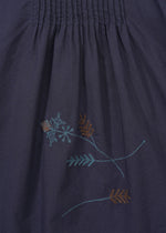 The DAMI LEAVES pants by HaaT are dark navy cotton with a gathered seam at the top and simple handmade Indian embroidery of light blue and brown floral and leaf motifs near the bottom center.