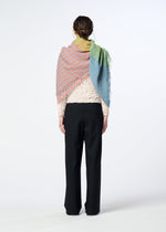 A person faces away, wearing black pants, a textured cream top, and the HaaT TRIPLY SQUARE STOLE—multicolored in pink, yellow, green, and blue with hand-finished fringe—draped over their shoulders.