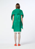 A person stands with their back to the camera, wearing the HaaT WALL WHITE HEM dress—vibrant green with an oversized collar or chiffon stole—paired with white tights and orange flats, set against a plain white background.