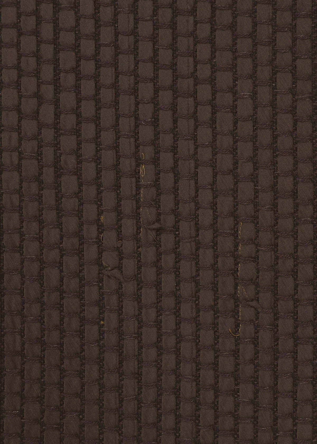 Zoomed view Close-up of SAKIORI by HaaT, a brown textured fabric featuring a vertical and horizontal grid pattern with subtle imperfections in the woven, gender-neutral material.