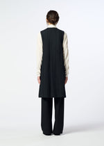 A person faces away, wearing the HaaT SAKIORI long black sleeveless vest over a light long-sleeve shirt and black pants against a plain background.