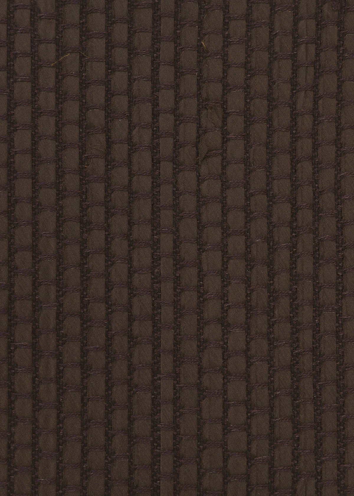 Zoomed view Close-up of SAKIORI by HaaT: dark brown woven fabric with a textured, grid-like pattern. Lighting accentuates the depth and traditional weaving-inspired structure.