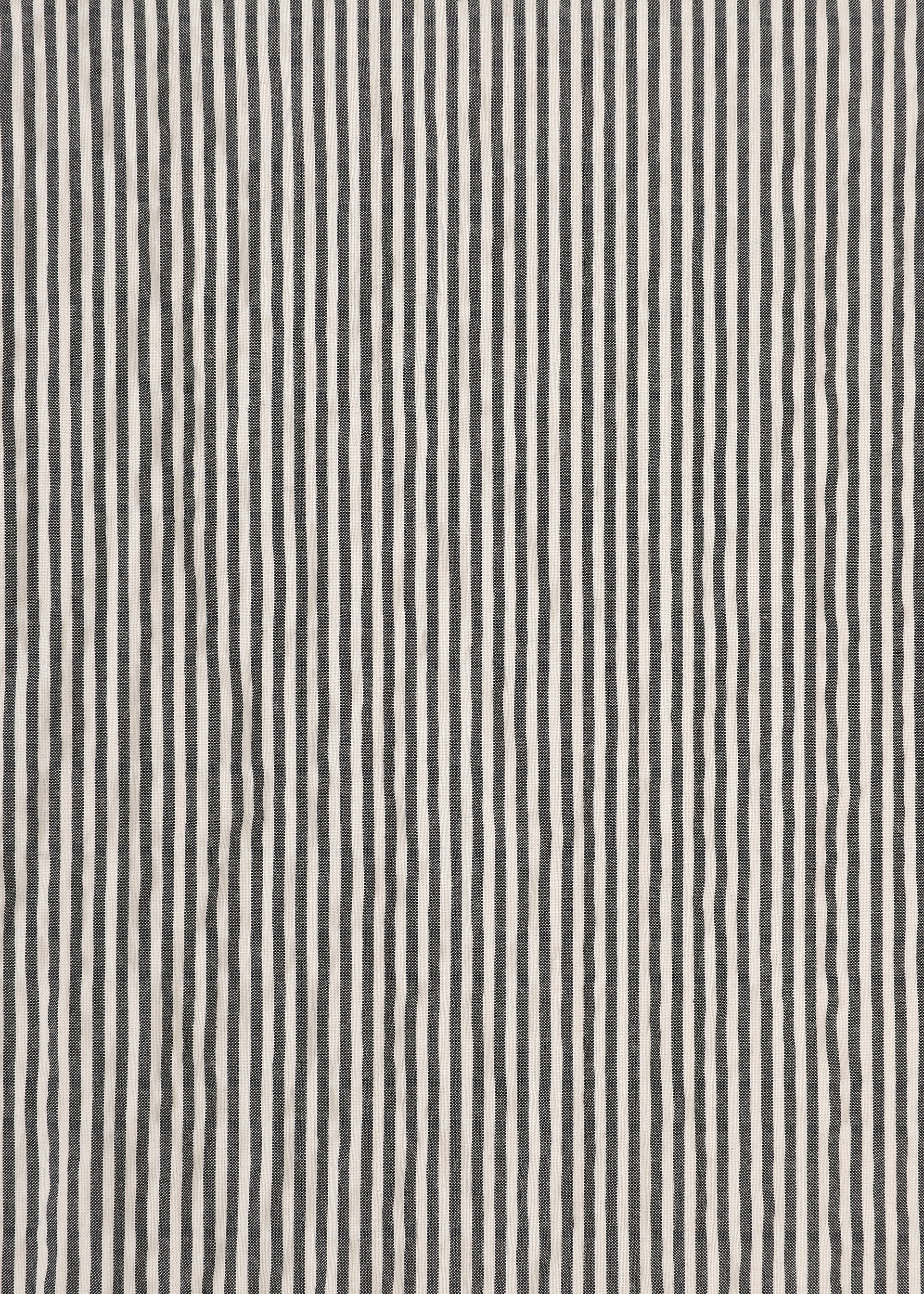 Zoomed view Wavy black and white vertical stripes in an irregular, hand-drawn style form a textured pattern across the surface, evoking the signature stretch of classic seersucker pants—this is RIPPLE STRIPE by HaaT.
