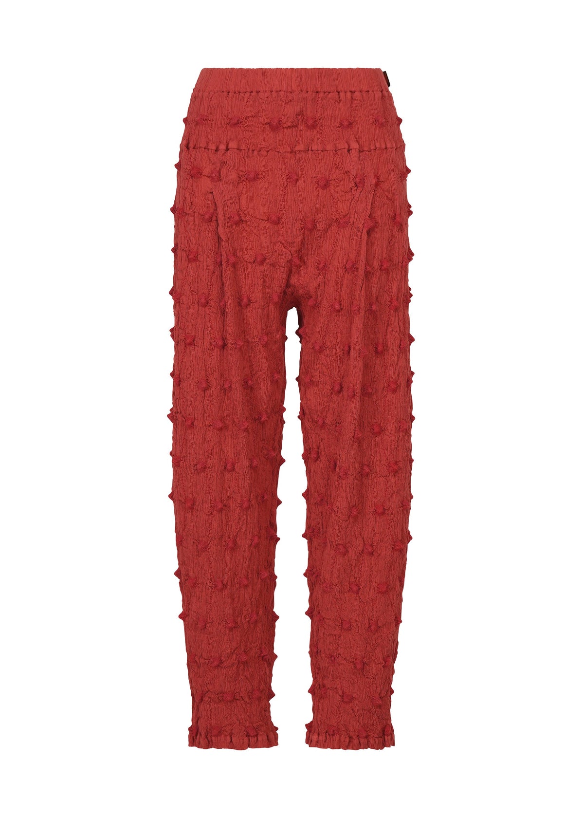 Crafted by HaaT, the KYO CHIJIMI SQUARE EMB pants feature a bold red hue and an ankle-length, high-waisted silhouette. These pants showcase an all-over raised, tufted dot motif that evokes the distinctive crinkled texture of classic KYO CHIJIMI styles. With a relaxed fit and a seamless appearance free of visible fasteners, they combine modern dimension with timeless appeal. view 2 of 9