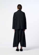 A person faces away, wearing the HaaT SAKIORI black woven suit with wide sarouel pants and matching shoes against a plain white background.