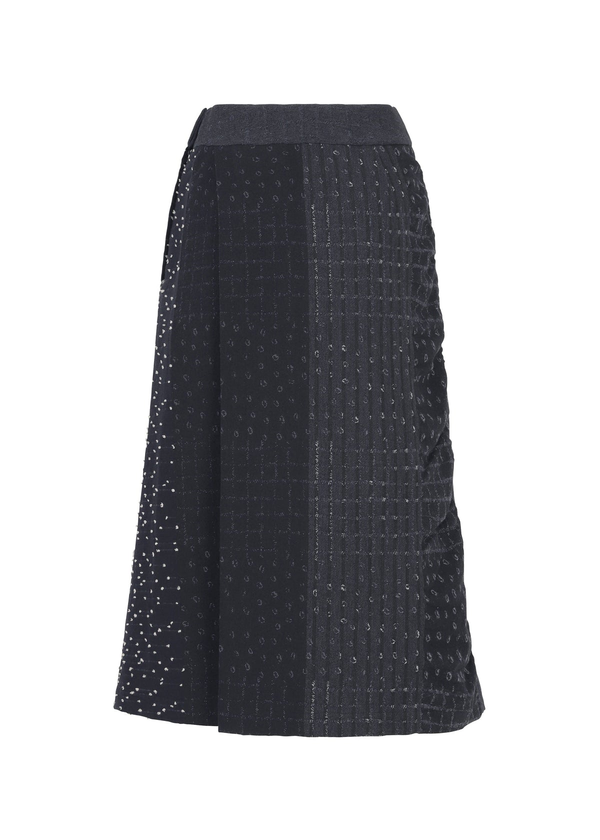 The COLLAGE STRETCH Ⅰ by HaaT is a black A-line midi skirt showcasing a patchwork pattern with subtle dotted embellishments, featuring varied textures and vertical paneling that evoke the timeless elegance of classic jacquard skirts. view 3 of 8
