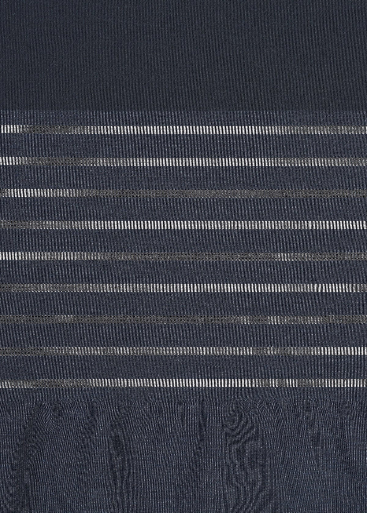 A subtle striped pattern is created on the COLLAGE STRETCH Ⅱ by HaaT, featuring a central horizontal section of dark blue fabric with evenly spaced thin light gray stripes, bordered above by solid dark blue fabric and below by slightly wrinkled blue fabric. view 5 of 8