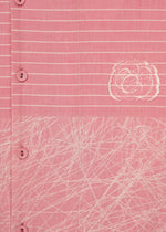 Close-up of HaaT's ONE STROKE DRAW: a pink cotton cupra dress with white buttons, horizontal white stripes, an abstract circular design, and a crisscrossing white pattern near the hem.