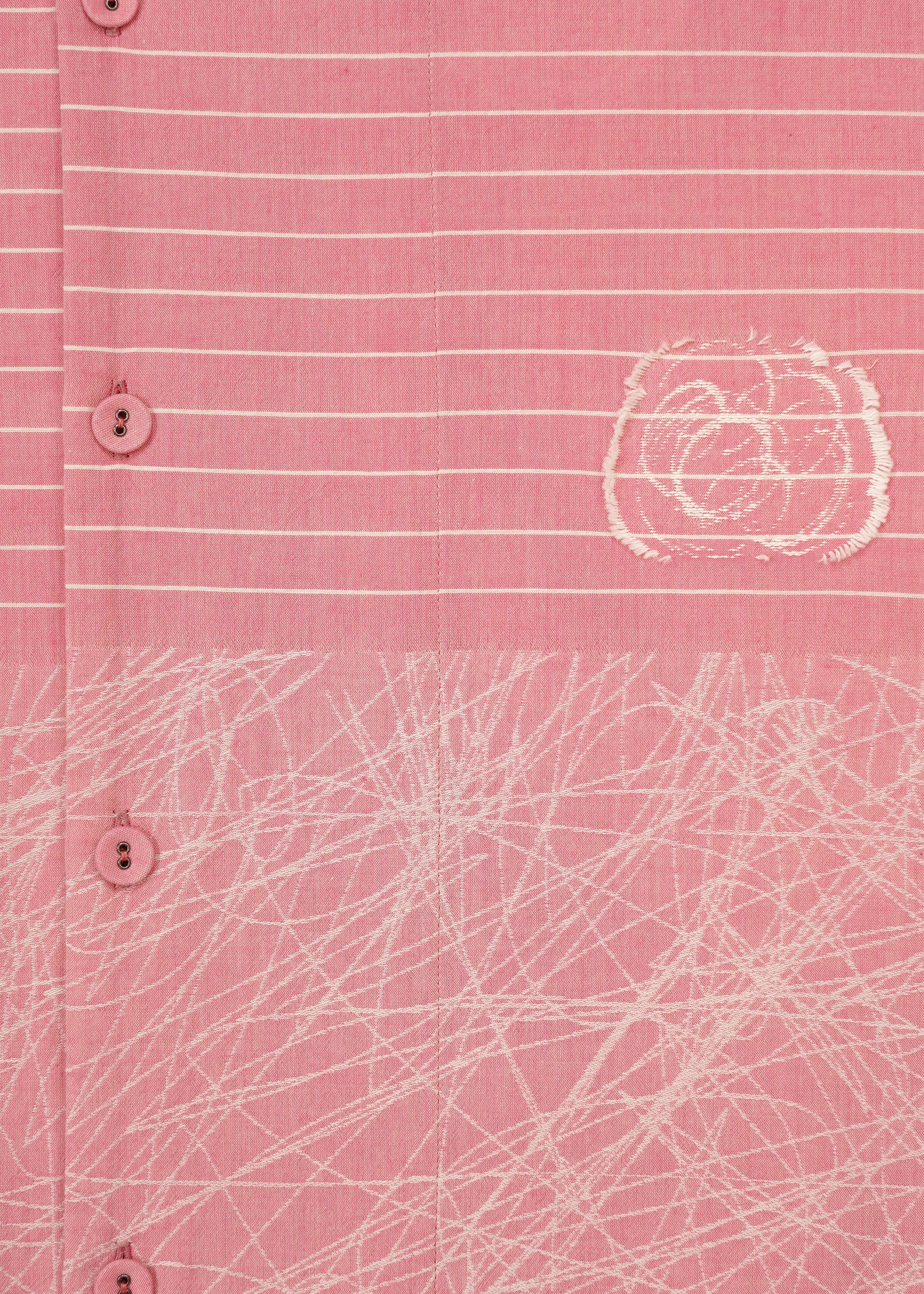 Zoomed view Close-up of HaaT's ONE STROKE DRAW: a pink cotton cupra dress with white buttons, horizontal white stripes, an abstract circular design, and a crisscrossing white pattern near the hem.