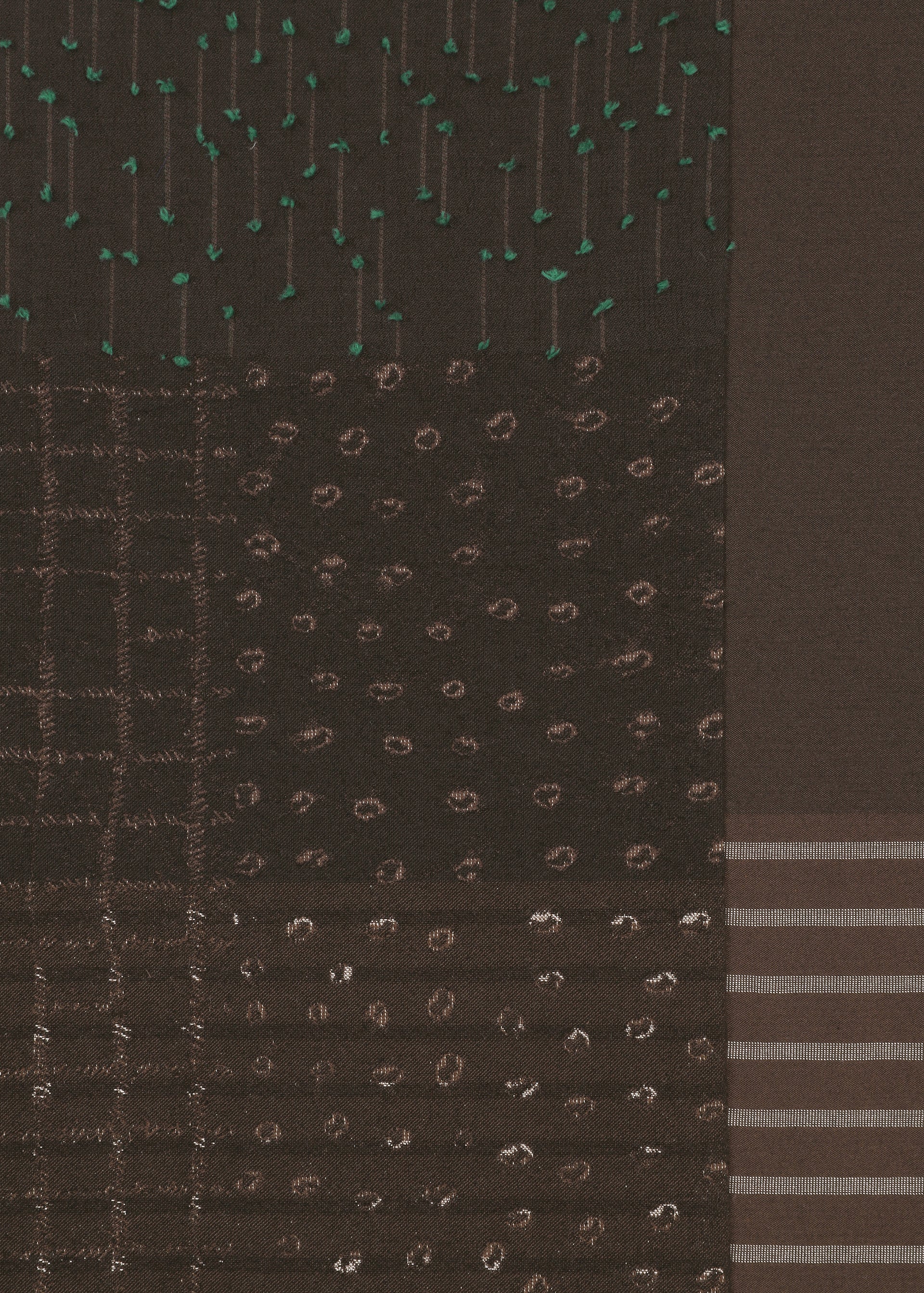 Zoomed view The COLLAGE STRETCH Ⅰ by HaaT features a dark fabric adorned with sections of various stitched patterns—dots, dashes, vertical lines, and horizontal stripes in green and brown threads—creating a geometric and textured design reminiscent of jacquard weaving.