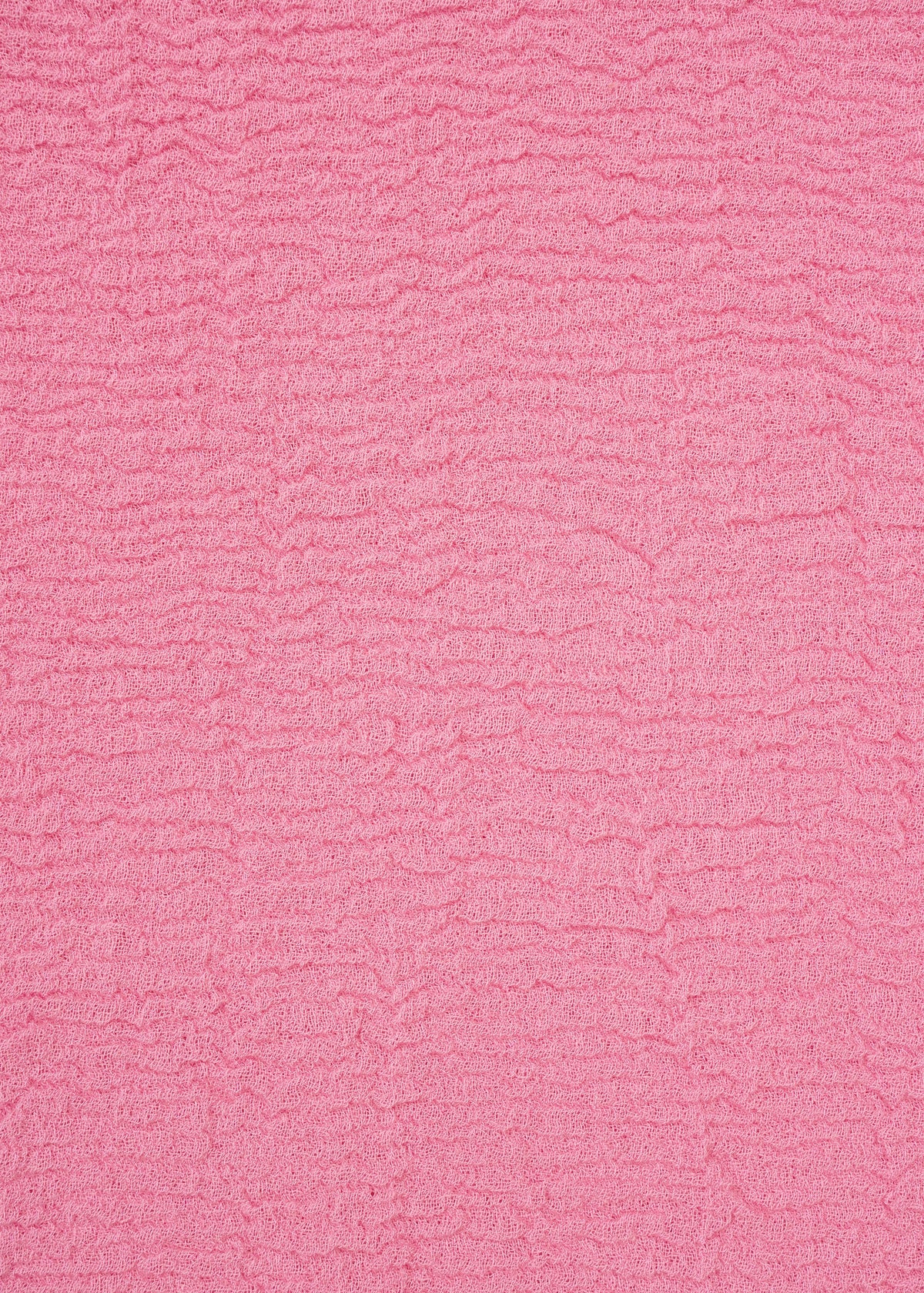 A close-up of a textured pink fabric with horizontal ripples and small wrinkles, creating a soft, wavy surface pattern across the entire image—distinctive of the unique product dyeing process used for the HaaT KYO CHIJIMI 2WAY top. view 5 of 8