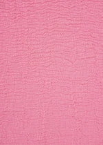 A close-up of a textured pink fabric with horizontal ripples and small wrinkles, creating a soft, wavy surface pattern across the entire image—distinctive of the unique product dyeing process used for the HaaT KYO CHIJIMI 2WAY top.