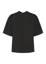 The RIPPLE STRIPE top by HaaT is a black short-sleeve seersucker shirt featuring a subtle wave striped pattern. Shown from the back, it has a relaxed fit and a straight hem.