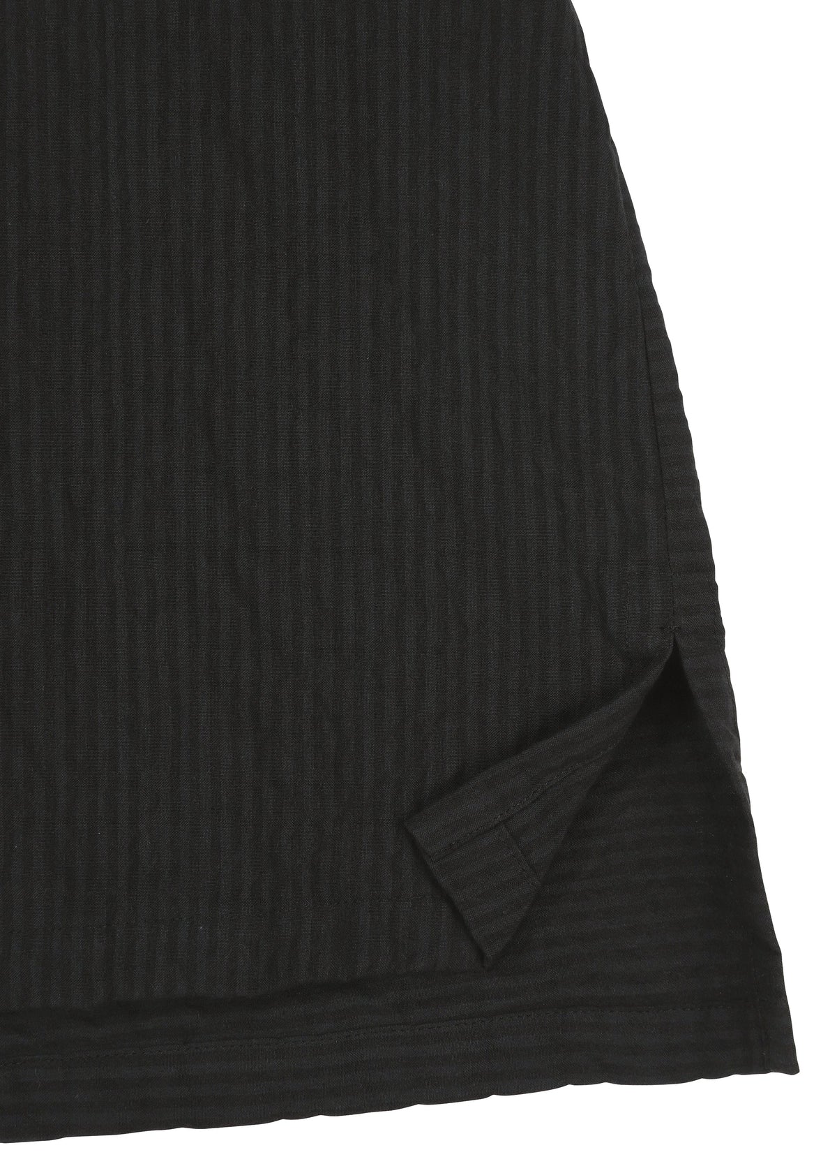 Close-up of the hem of HaaT’s RIPPLE STRIPE fabric in black, featuring a wave striped pattern and a small triangular slit at the edge that reveals an inner layer. view 4 of 7