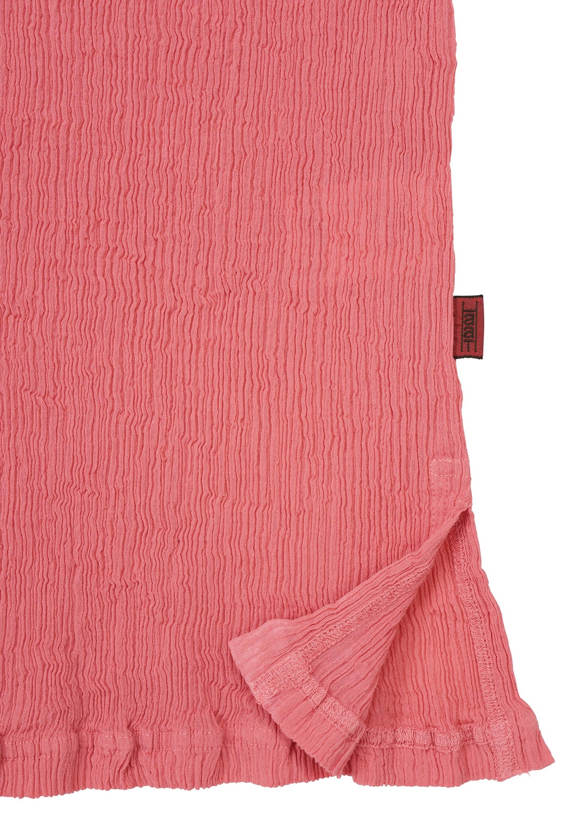 A textured, crinkled pink fabric in the signature KYO CHIJIMI AUGUST style by HaaT, crafted from ultra-fine cotton with subtly ruffled edges. One corner is folded over to reveal the delicate crinkled underside, while a small maroon fabric tag is sewn into the seam. view 4 of 7