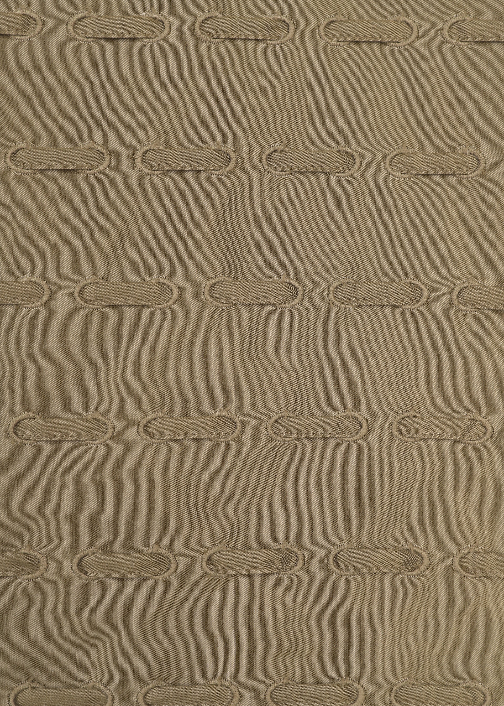Zoomed view HOLE & LINE by HaaT is crafted from brown cupra-blend fabric with a subtle striped texture, featuring evenly spaced horizontal rows of oval-shaped stitched holes that create an elegant eyelet embroidery effect.