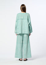 A person with long brown hair, seen from behind, wears HaaT's ONE STROKE DRAW—a loose light teal jacquard cotton cupra top and matching wide-leg pants—paired with black flat sandals, set against a plain white background.