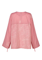 The ONE STROKE DRAW top by HaaT is a pink jacquard long-sleeved piece with wide sleeves, featuring mixed horizontal stripes and abstract white line patterns. Made from a cotton cupra blend, it offers a round neckline and loose fit.