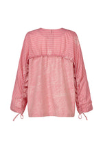 Back view of HaaT's ONE STROKE DRAW: a loose-fitting, long-sleeved pink cotton cupra jacquard top with horizontal white sleeve and back stripes, abstract white patterns, and adjustable drawstrings at the cuffs.