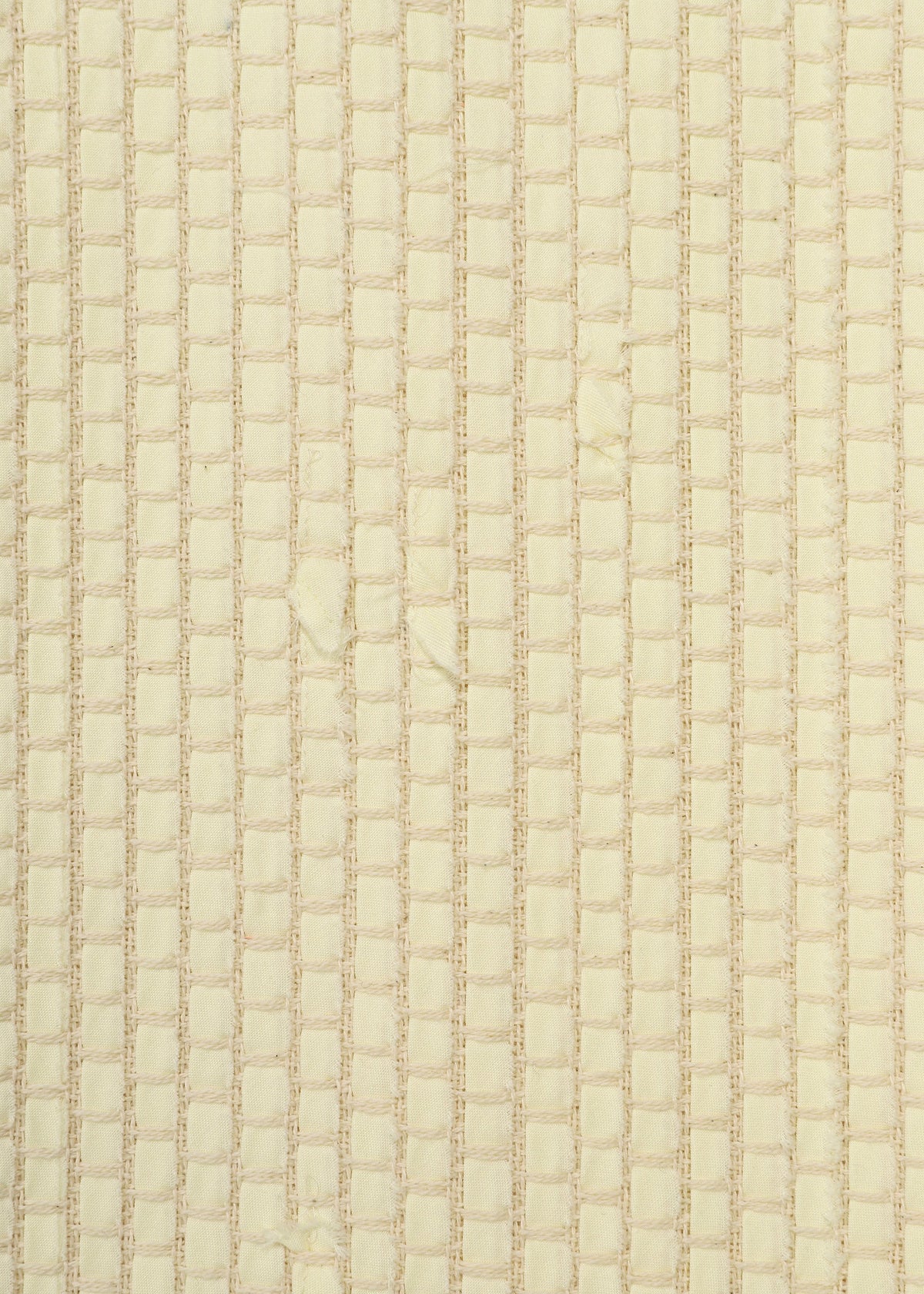 Zoomed view Close-up of HaaT’s SAKIORI: a beige textured fabric featuring a grid-like, woven pattern with a soft, slightly shiny surface reminiscent of traditional techniques.