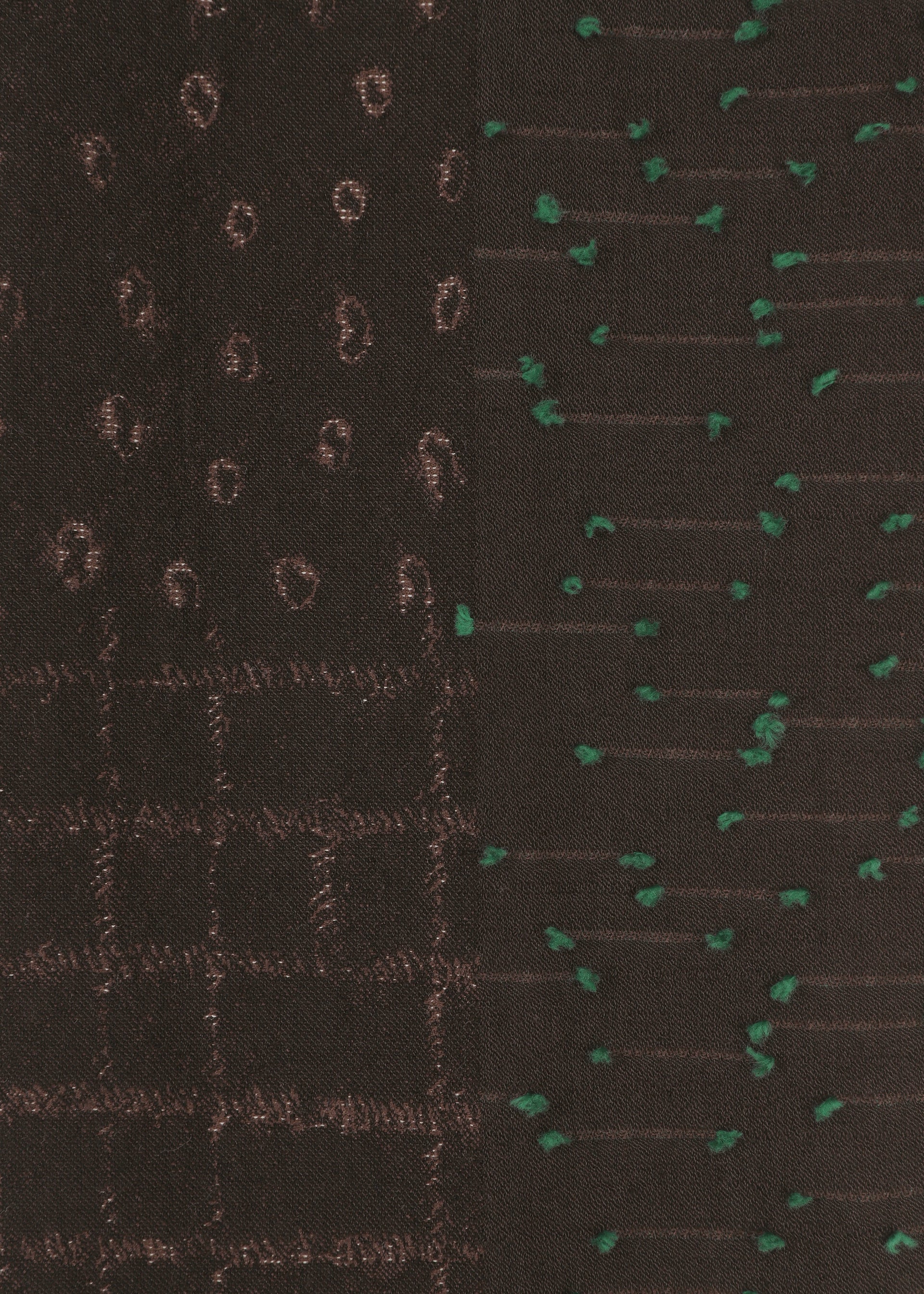 Zoomed view Close-up of HaaT’s COLLAGE STRETCH Ⅰ fabric in dark brown, featuring three jacquard-inspired stitched patterns: brown circles, a check-like brown grid, and scattered green dots—each arranged in vertical side-by-side sections.