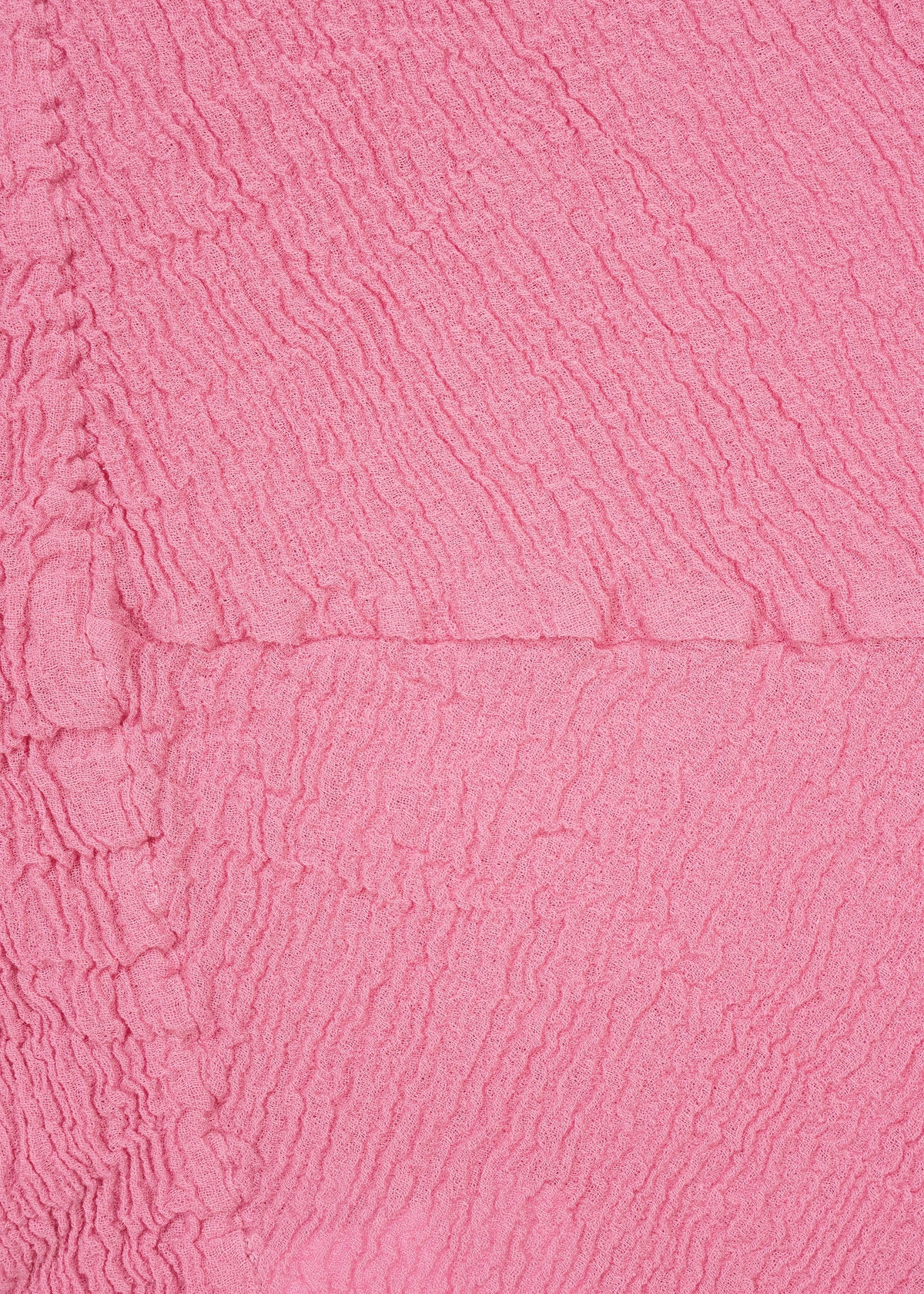 Close-up of textured, crinkled pink fabric featuring irregular horizontal and vertical lines that create the distinctive KYO CHIJIMI crinkle texture, as seen in the HaaT KYO CHIJIMI 2WAY. view 5 of 8