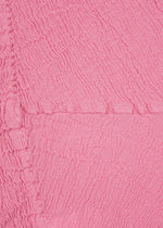 Close-up of textured, crinkled pink fabric featuring irregular horizontal and vertical lines that create the distinctive KYO CHIJIMI crinkle texture, as seen in the HaaT KYO CHIJIMI 2WAY.