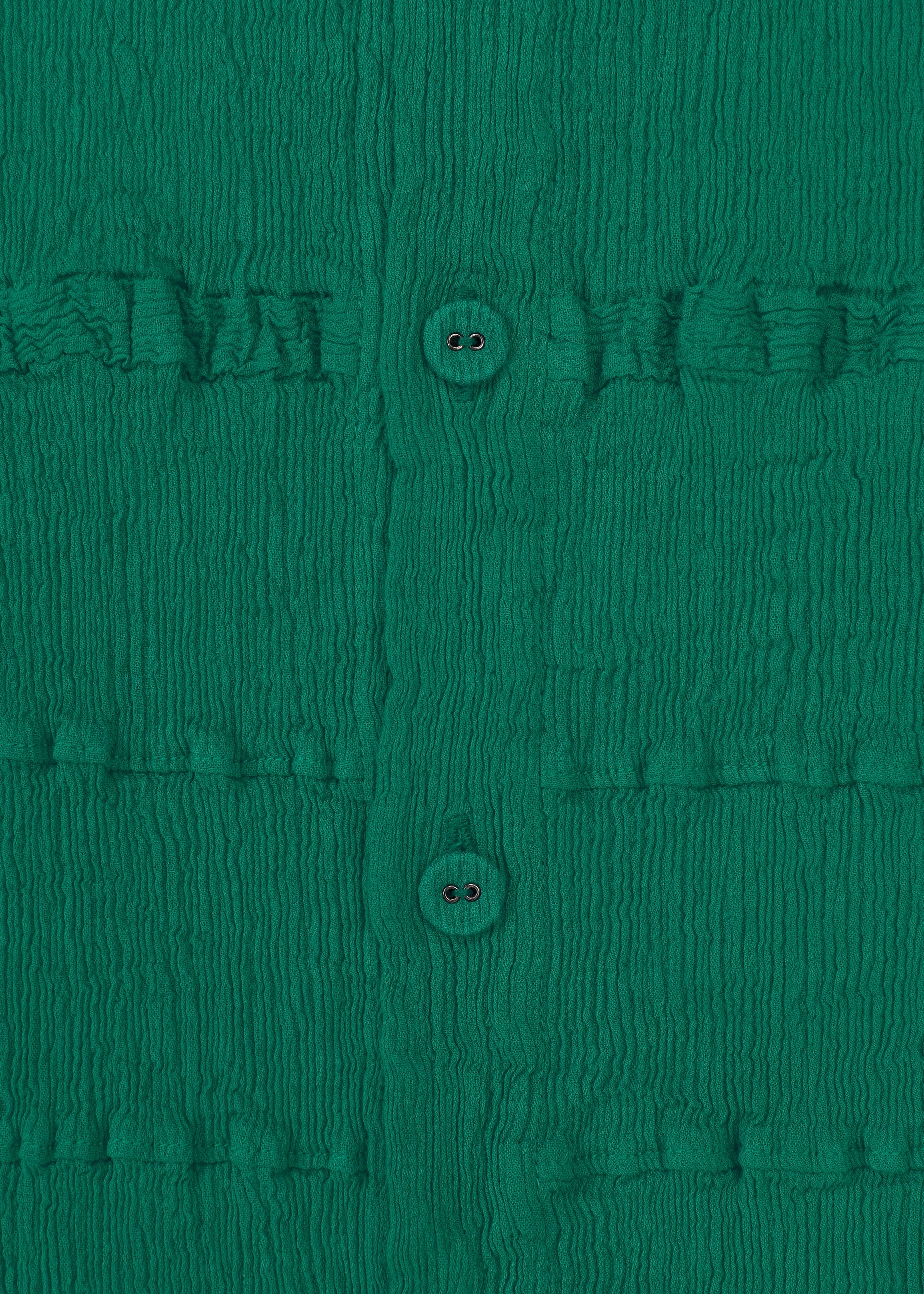 Zoomed view Close-up of KYO CHIJIMI TSUCHIKABE by HaaT: ultra-fine cotton green fabric with a crepe texture, vertical row of two buttons, and subtle grid pattern formed by horizontal stitched lines.