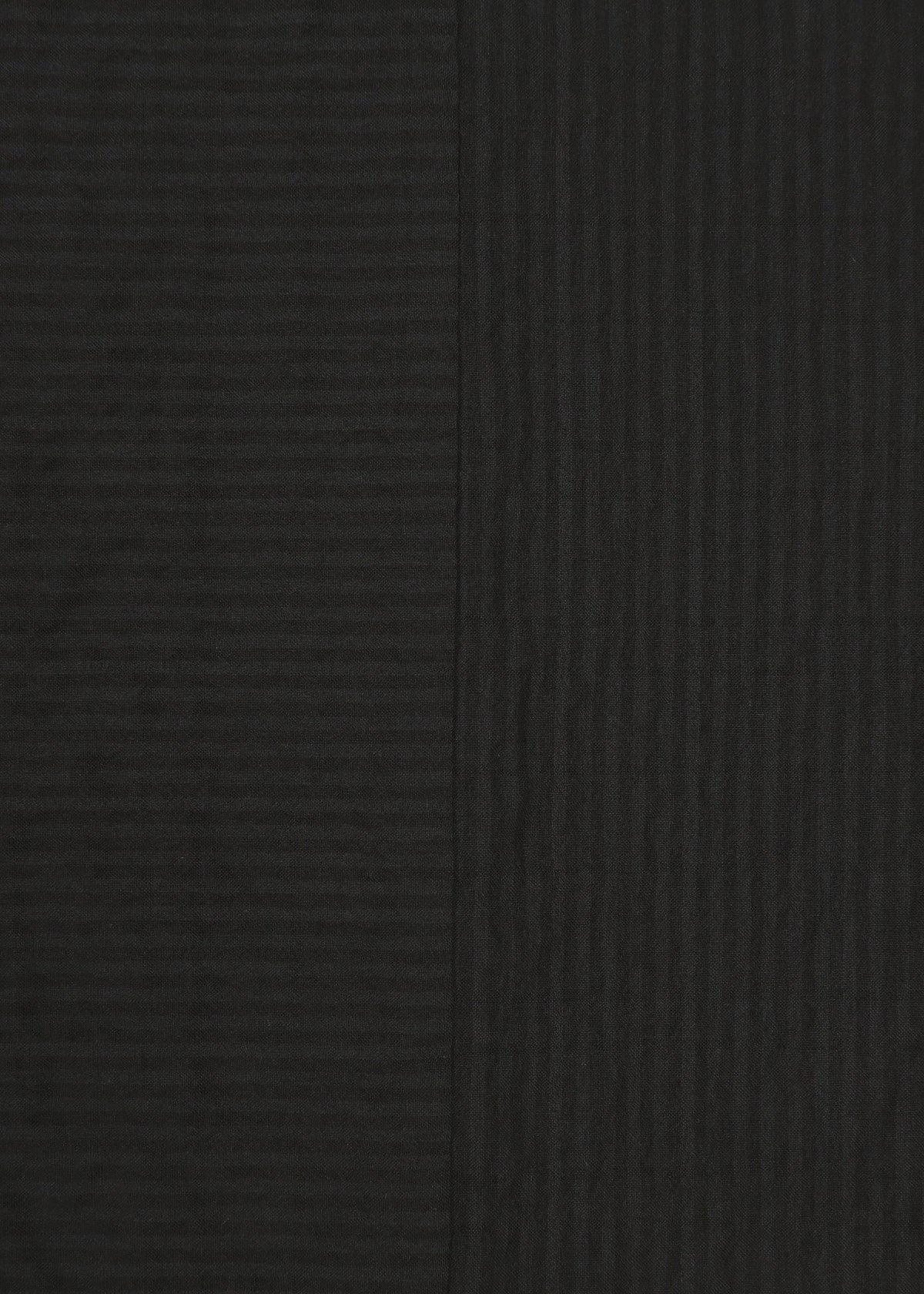Two dark panels of HaaT’s RIPPLE STRIPE fabric are displayed side by side. Featuring a sophisticated wave-striped pattern, the left panel appears slightly lighter while the right panel is a deeper black; both showcase subtle texture and vertical lines. view 5 of 8