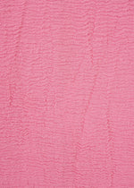 Textured pink fabric from HaaT’s KYO CHIJIMI 2WAY collection, featuring horizontal rippled lines that form a wavy pattern across the surface. Inspired by traditional KYO CHIJIMI tunic textiles, the material has a soft, tactile look and displays consistent color throughout.